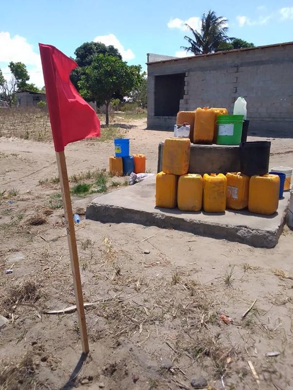 The red flag marks a polluted water source. (c) Women Water Watch