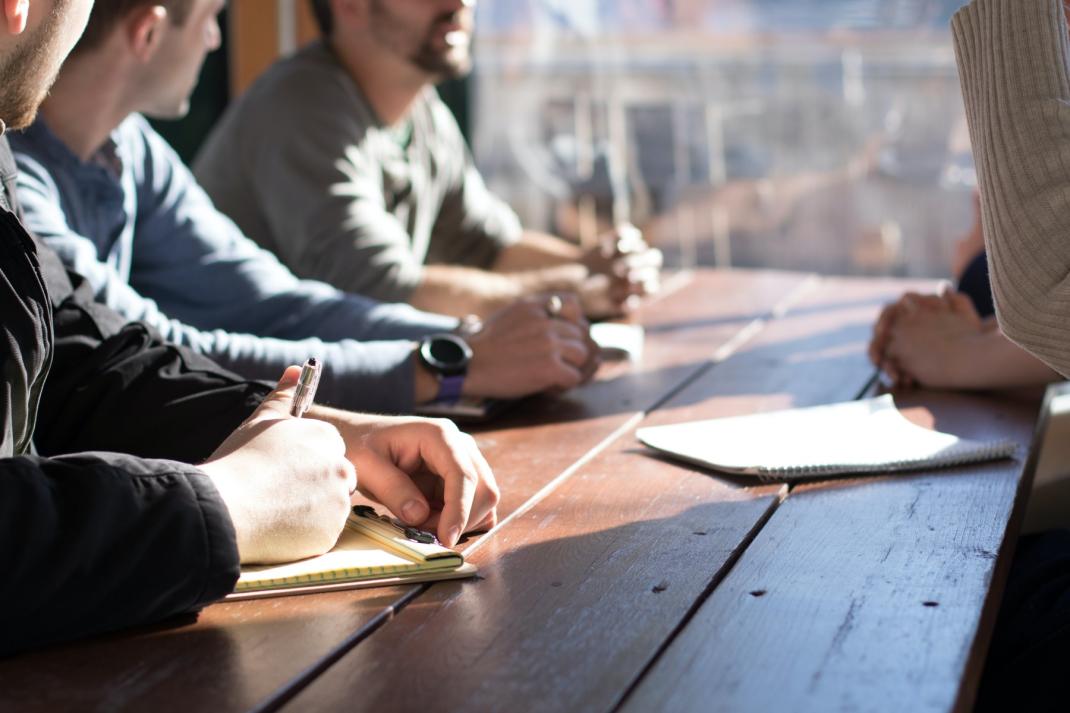 People discussing at a garden table